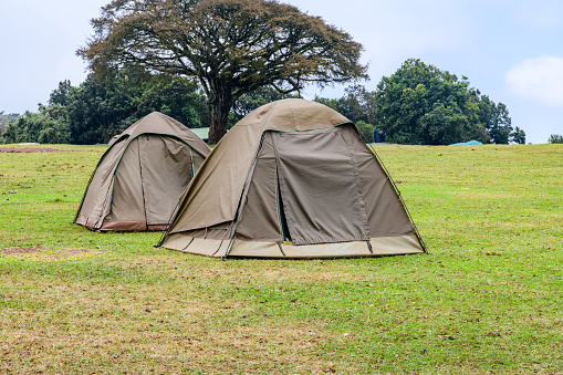 View of the camping site with the big dome tent. and. the cabin on the volcanic valley on Mount Kilimanjaro