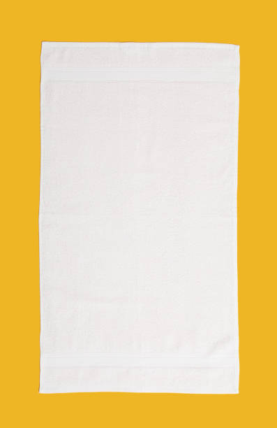 istock White beach towel on yellow background, top view 1394230323