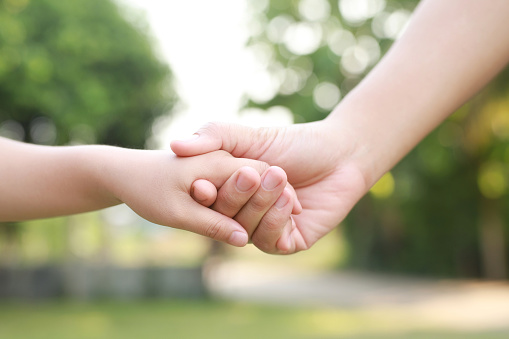 Children's hands with the warmth of mother's care