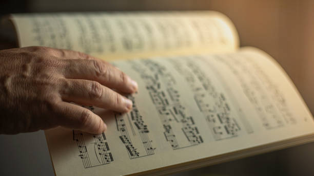 istock close-up of an older man's hand caressing a classical music sheet with musical notes 1394232901