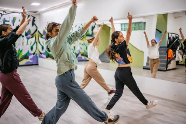 Beautiful young active women dancing hip-hop in a dance studio.