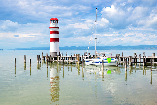 Lighthouse with wooden pier in Podersdorf am See, a small village on Lake Neusiedler with the longest beach in Burgenland, Austria.