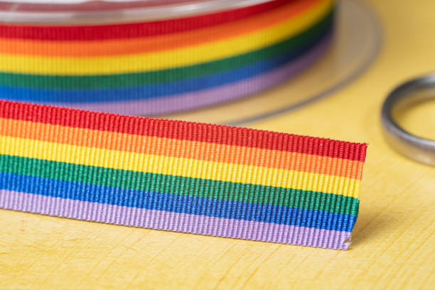 istock Rainbow ribbon of LGBT on yellow background 1394236759