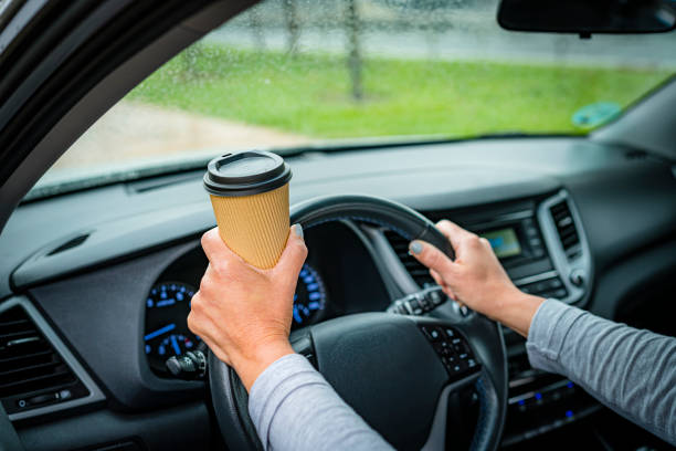 istock Driving a car and drinking coffee 1394236924