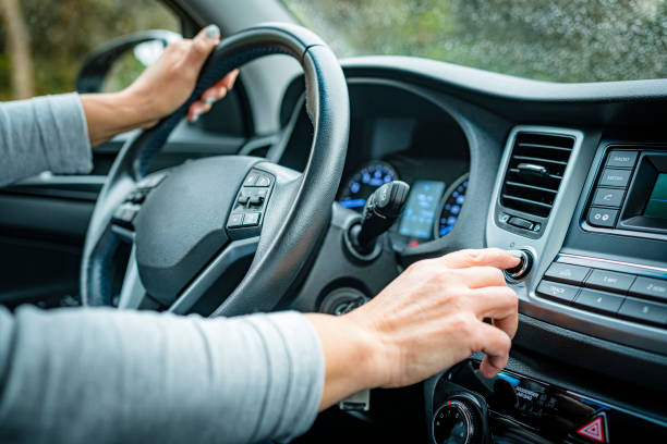 istock Adjusting car stereo button while driving in a rainy day 1394236934
