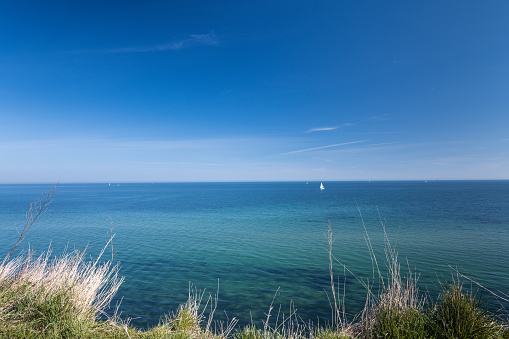 Landscape of blue Baltic sea with white sand and cloudy sky in north Germany