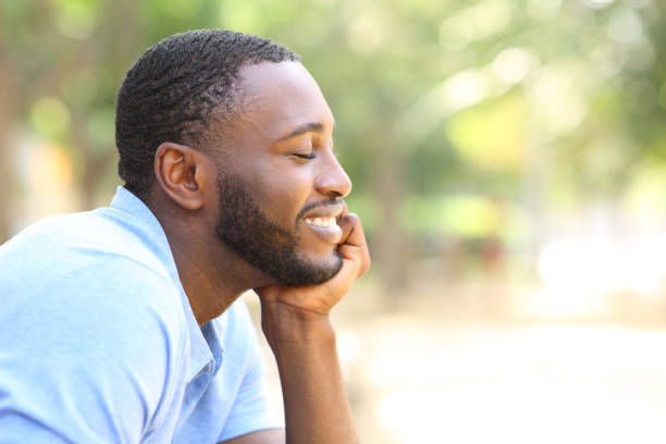 istock Happy man with black skin relaxing in a park 1394241510