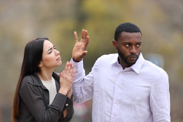 istock Man rejecting a woman who is begging 1394242428