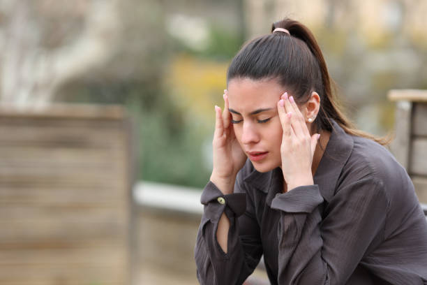 istock Teen suffering migraine complaining sitting on a bench 1394242537