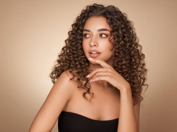 istock Beautiful smiling woman with afro curls 1394244900