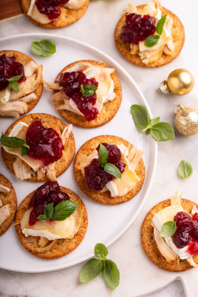istock Party appetizers with turkey, brie and cranberry sauce 1394250820