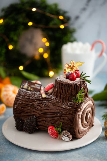 Yule log chocolate cake with frosting for Christmas stock photo