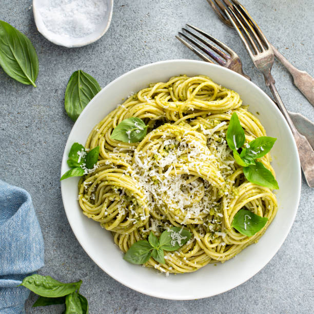 Basil pesto pasta with parmesan and olive oil stock photo
