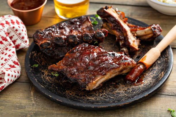 istock Grilled barbeque ribs with BBQ sauce and sides 1394250910