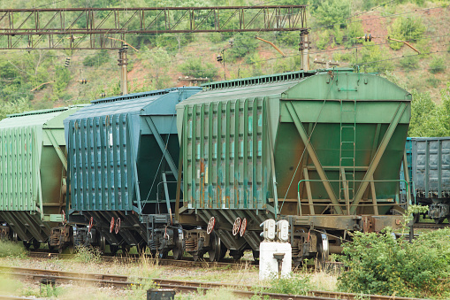 Old multicolored freight cars at the marshalling yard in the summertime