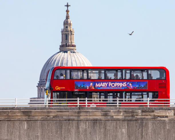 Red London Bus going over Waterloo Bridge in London, UK London, UK - April 20th 2022: A red London bus travelling over Waterloo Bridge with the the dome of St. Pauls Cathedral in the background, in London, UK. waterloo bridge stock pictures, royalty-free photos & images