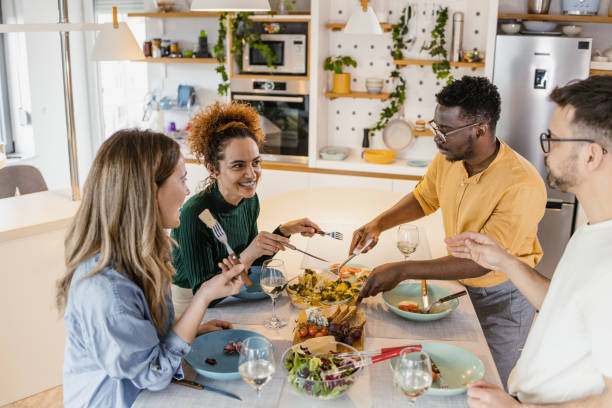 istock Friends eating together at home 1394257818