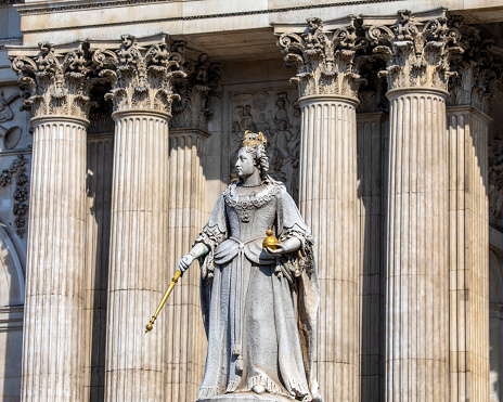 London, UK - April 20th 2022: Statue of Queen Anne with the magnificent facade of St. Pauls Cathedral in the background, in the city of London, UK.