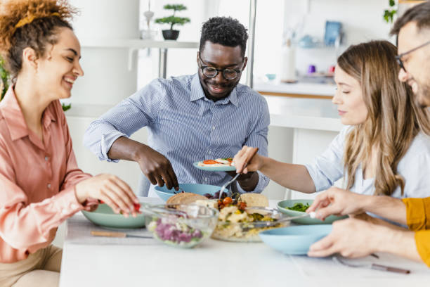 istock Friends eating together at home 1394259823