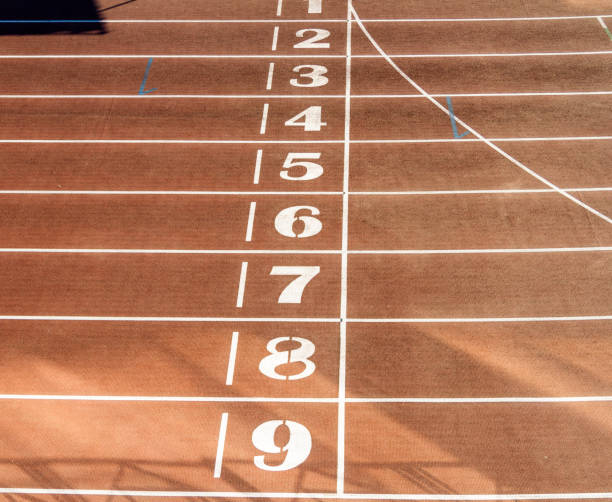 istock Orange running track with markings in the stadium. 1394259921