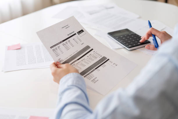 istock Busy person with business documents using calculator 1394260057