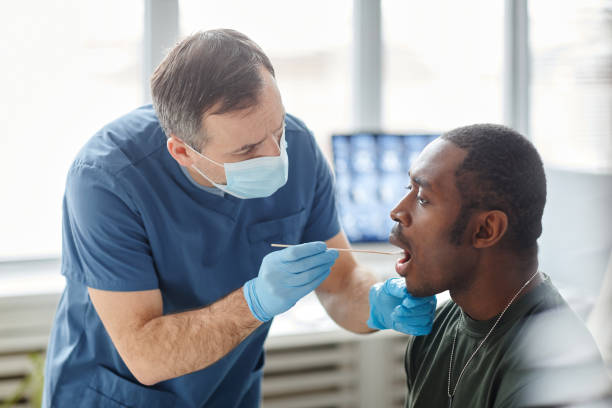 istock Putting Swab Stick Into Patients Mouth 1394260817