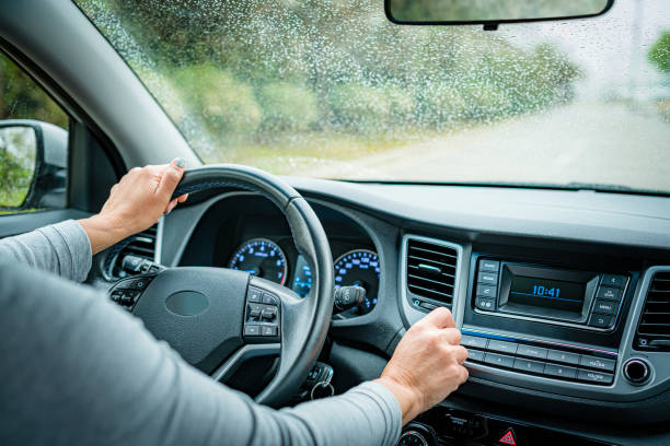 Adjustingcar stereo volume while driving in a rainy day