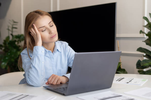 istock Tired employee sit behind laptop, take nap 1394261353