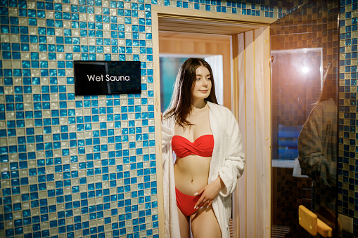 Beauty, spa, healthy lifestyle concept. Beautiful young girl relaxing at luxury spa in wet sauna