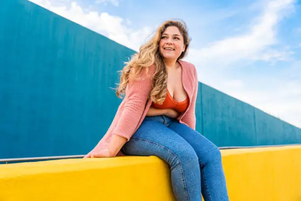 Photo of Beautiful plus size young woman outdoors