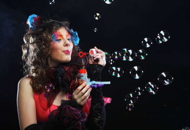 istock Fashionable young model female with creative make-up blowing soap bubbles. Doll style 1394268962