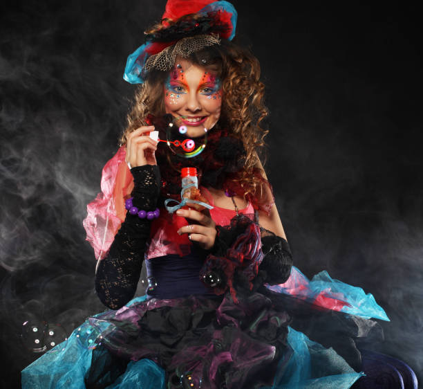 istock Fashionable young model female with creative make-up blowing soap bubbles. Doll style 1394268972