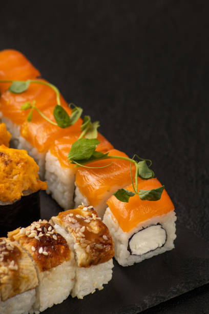 istock Japanese sushi rolls on a black background macro 1394269658