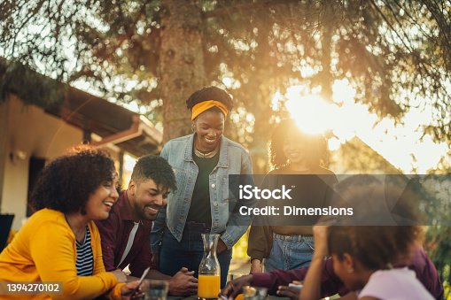istock African-American family playing card outdoors 1394270102