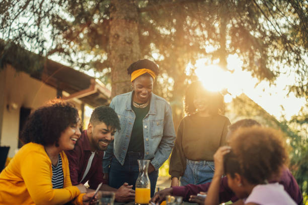 African-American family playing card outdoors Huge african american family playing board games outdoors family playing card game stock pictures, royalty-free photos & images