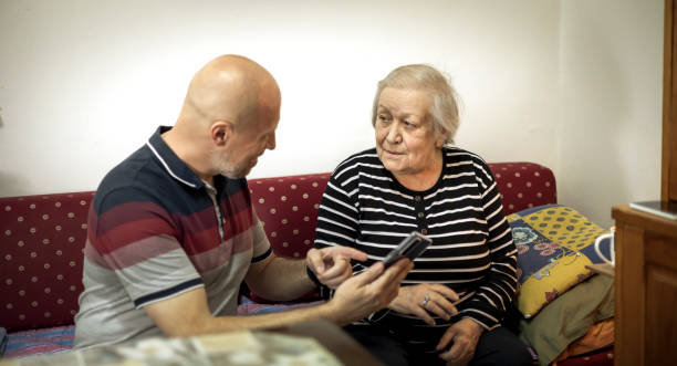 istock Caring son helping his mother in her house 1394270665