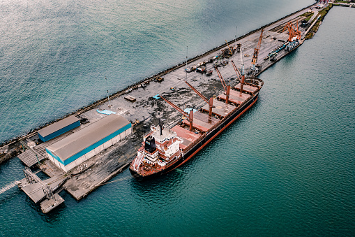 Drone Point View of Cargo Ship in the Port. Aerial view of Coal Ship in a port.