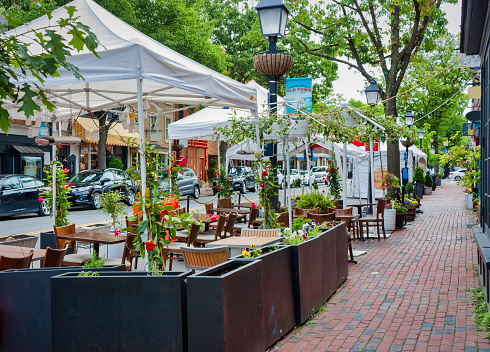 Dining tables outdoors on Prince Street in Old Town Alexandria on a summer day.