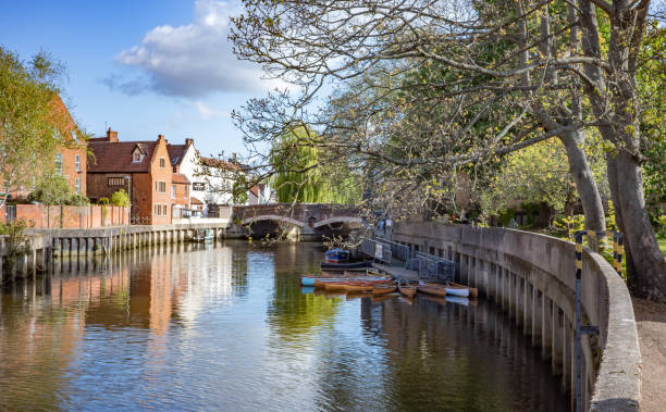 A view along the developed River Wensum on a bright and sunny morning