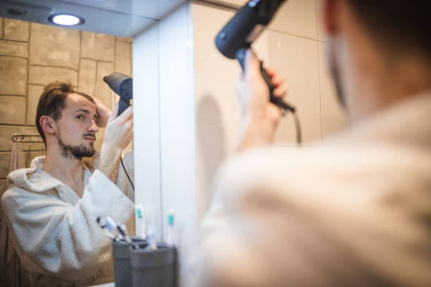 istock Handsome middle aged man drying his hair 1394278141