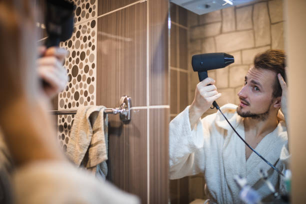 istock Handsome middle aged man drying his hair 1394278143