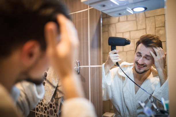 istock Handsome middle aged man drying his hair 1394278146
