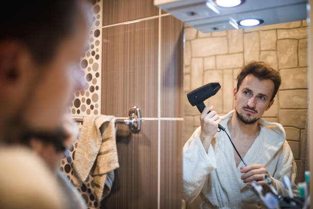 istock Handsome middle aged man drying his hair 1394278147