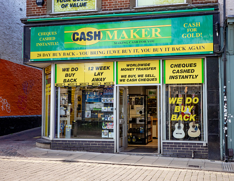 Norwich, Norfolk, UK  - April 26 2022. Pawnbroker's shop in a rundown part of the city
