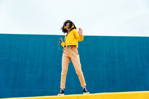 istock Young happy woman dancing and having fun outdoor 1394281162