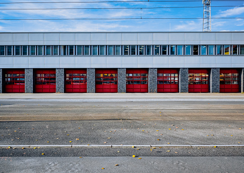 behind the closed gates of the fire station, firefighters wait for an emergency call.