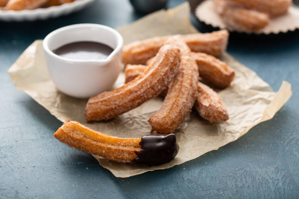 istock Homemade churros with cinnamon sugar on parchment 1394283237