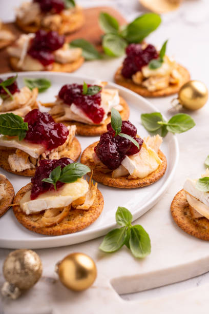 istock Party appetizers with turkey, brie and cranberry sauce 1394283252
