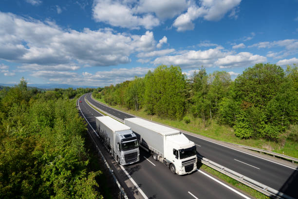 istock Overtaking trucks on the highway in the forested landscape 1394283504