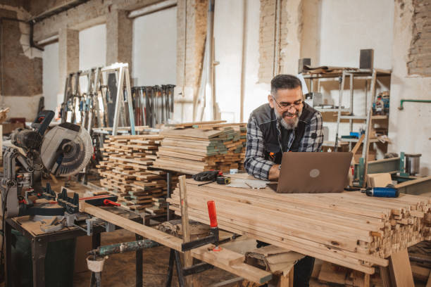 Carpenter in wood workshop stock photo